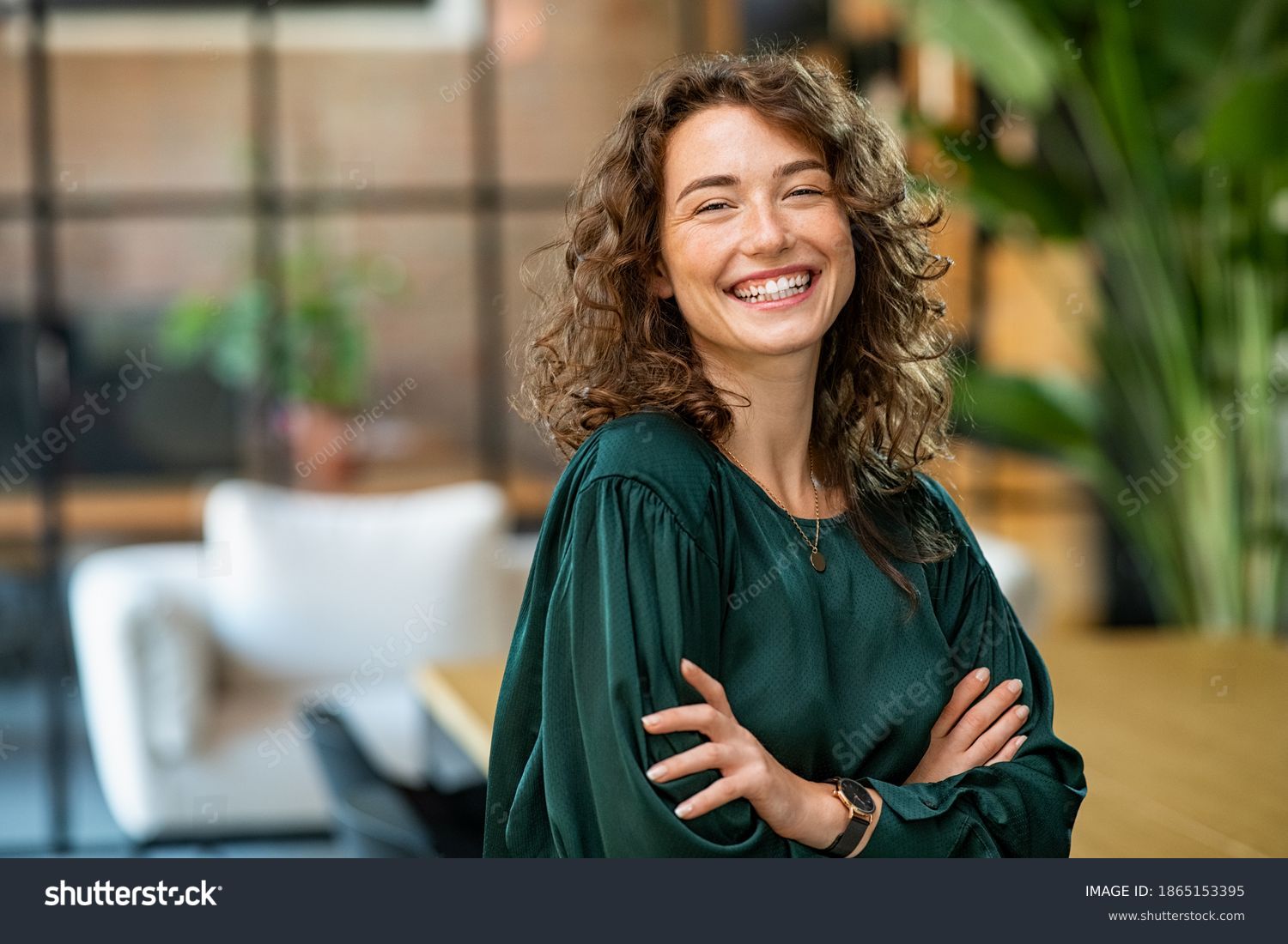 files/stock-photo-portrait-of-young-smiling-woman-looking-at-camera-with-crossed-arms-happy-girl-standing-in-1865153395.jpg